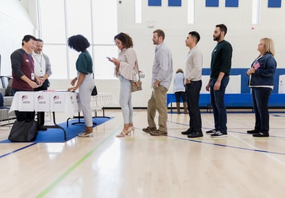 Voters in line at a school gymnasium
