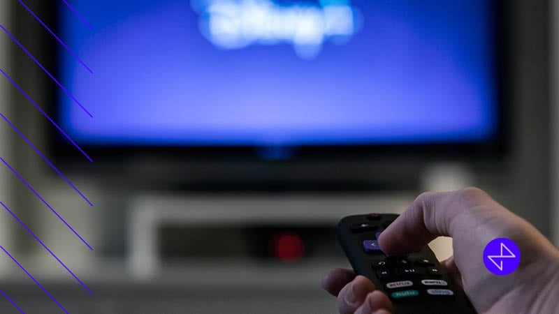 Person using smart tv to access CTV or OTT ads that uniquely target viewers